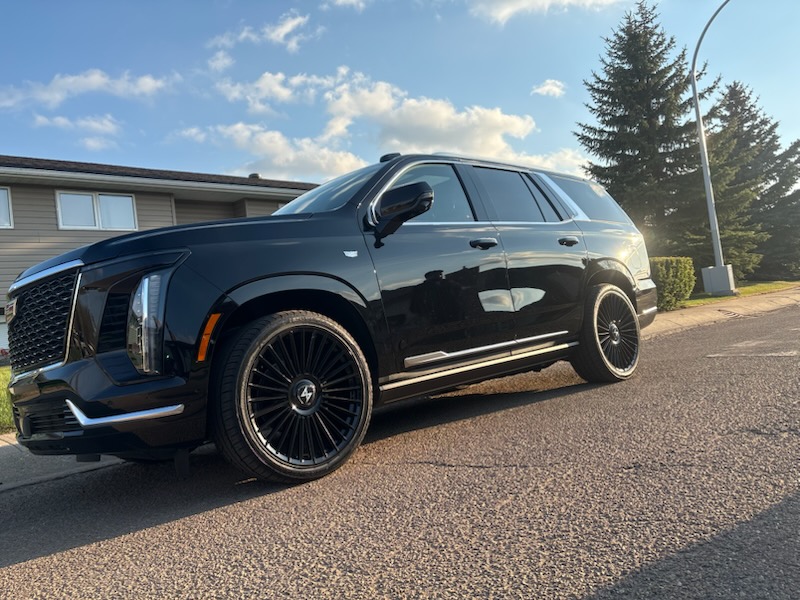 Black Cadillac Escalade on gloss black multi-spoke wheels
