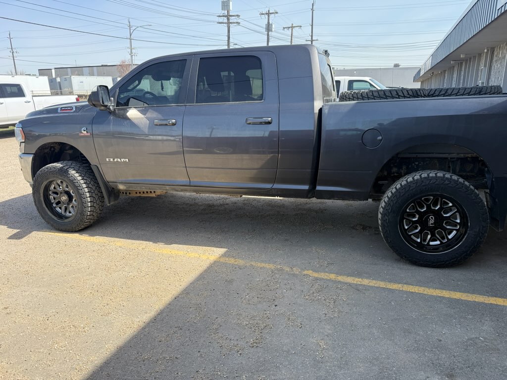 Gray Ram 2500 mega cab on gloss black wheels