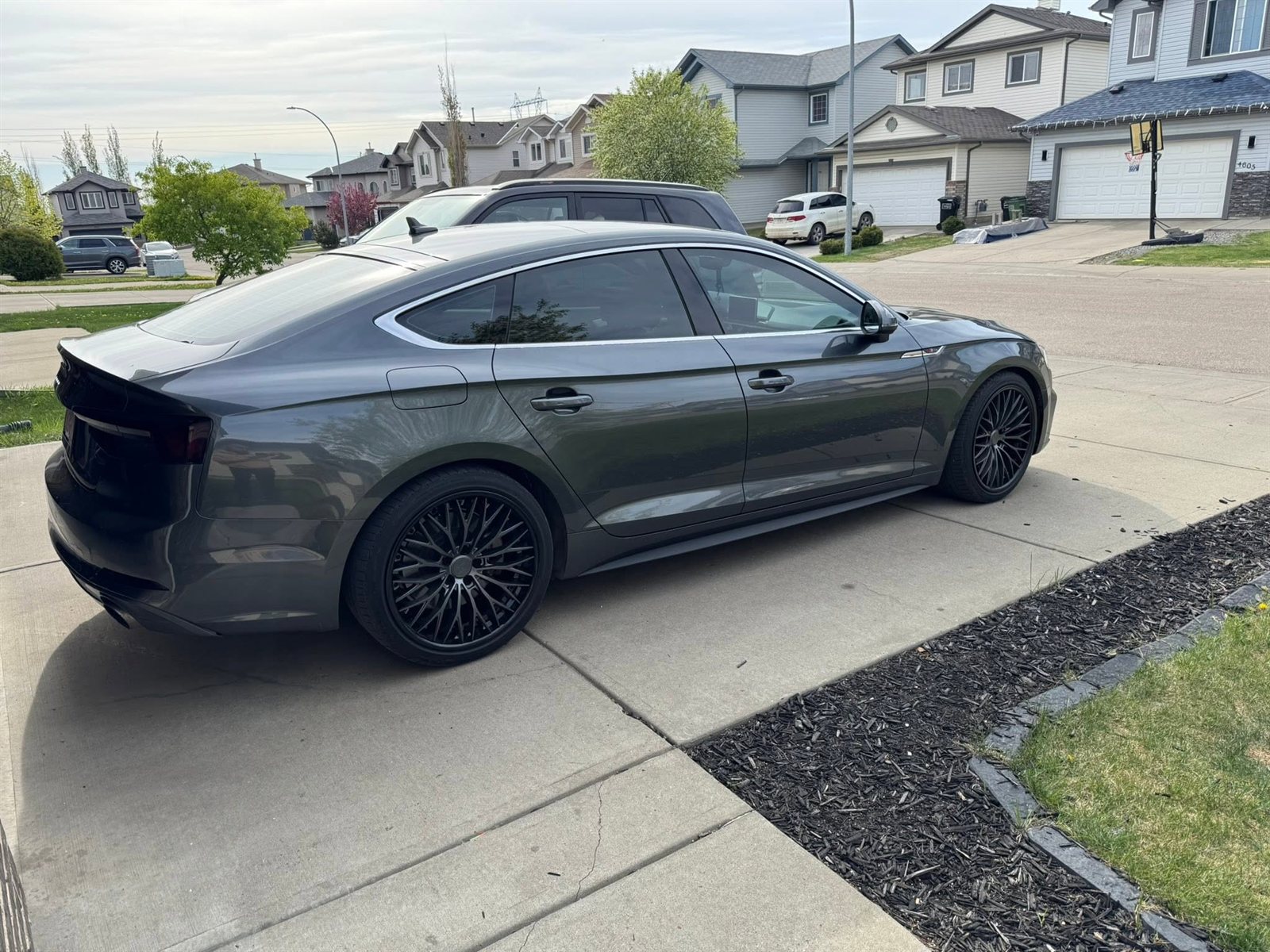 Grey Audi A5 Sportback on gloss black multi-spoke wheels