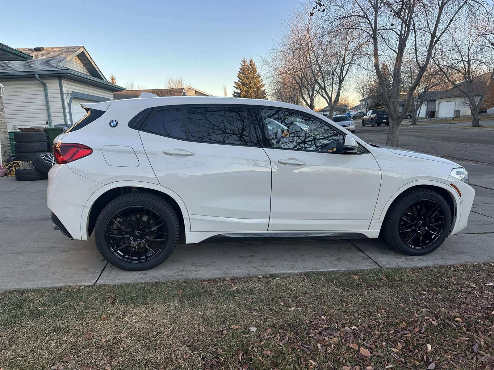 White BMW X2 on gloss black multi-spoke wheels
