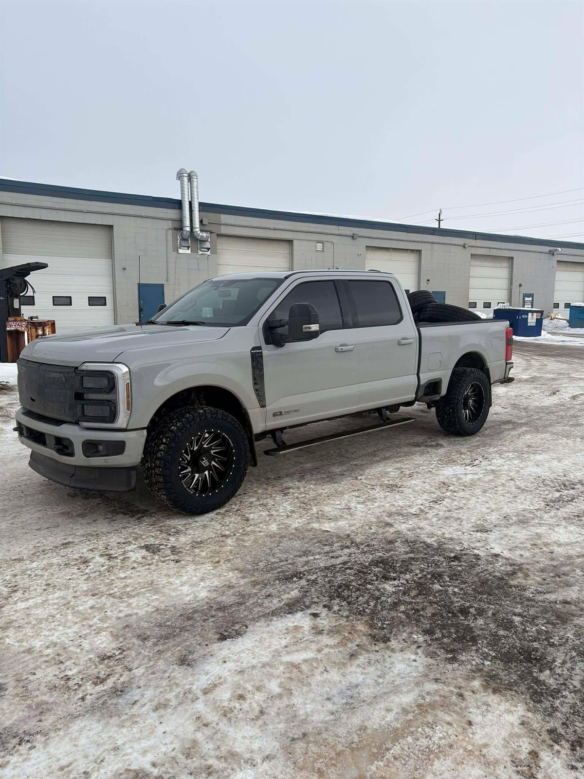 Avalanche grey Ford F-250 Platinum Power Stroke on black milled wheels