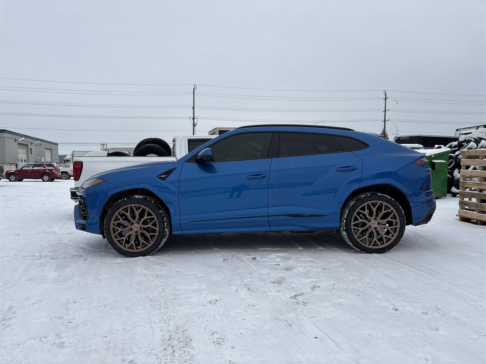 Blue Lamborghini Urus on bronze wheels with winter tires